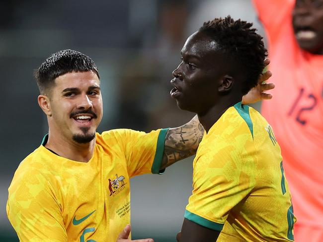 SYDNEY, AUSTRALIA - MARCH 24: Garang Kuol (r) of the Socceroos celebrates with Marco Tilio of the Socceroos after scoring a goal during the International Friendly match between the Australia Socceroos and Ecuador at CommBank Stadium on March 24, 2023 in Sydney, Australia. (Photo by Mark Kolbe/Getty Images)