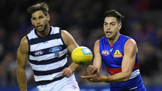 Brad Lynch of the Bulldogs (right) and Tom Hawkins of the Cats contest during the Round 15 AFL match between the Western Bulldogs and the Geelong Cats at Etihad Stadium in Melbourne, Friday, June 29, 2018. (AAP Image/Julian Smith) NO ARCHIVING, EDITORIAL USE ONLY