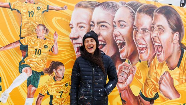 Melbourne artist Danielle Weber in front of her mural of the Matildas on the Bondi Beach front walk. Picture: NCA NewsWire / David Swift