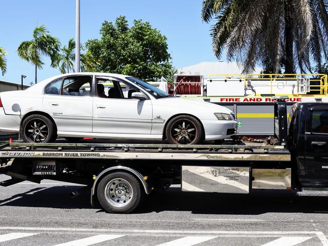 Queensland Police and Queensland Fire Department officers respond to an emergency at the General Aviation area of the Cairns Airport, where a man suffered life threatening injuries after being crushed by a car in the carpark of Hinterland Aviation. The car is removed from the Hinterland Aviation carpark. Picture: Brendan Radke