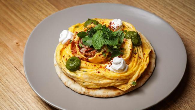 Ivy and Pearl’s chilli folded eggs on charred flatbread with fried bacon, Aleppo pepper, spring onion, Persian fetta and green harissa. Picture: Nicole Cleary