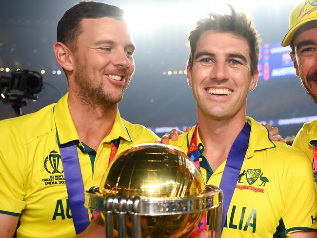 AHMEDABAD, INDIA - NOVEMBER 19: Josh Hazlewood, Pat Cummins and Mitchell Starc of Australia pose for a photo with the ICC Men's Cricket World Cup Trophy after  the ICC Men's Cricket World Cup India 2023 Final between India and Australia at Narendra Modi Stadium on November 19, 2023 in Ahmedabad, India. (Photo by Alex Davidson-ICC/ICC via Getty Images)