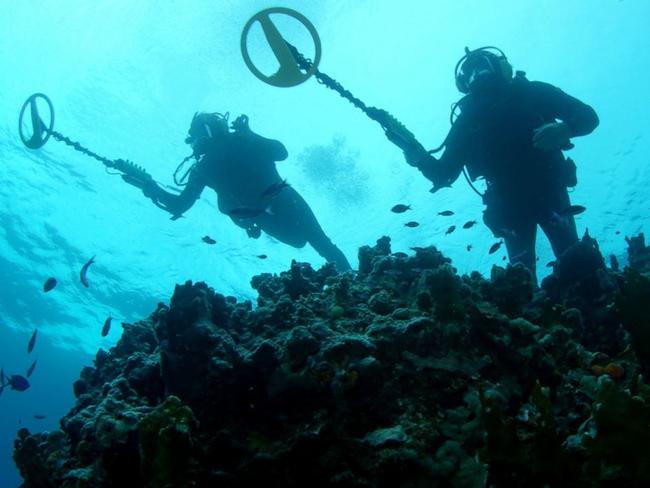 Underwater treasure hunters scan the sea.