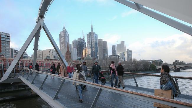 Walking across the Evan Walker bridge from Southbank into the CBD. Picture: Ian Currie