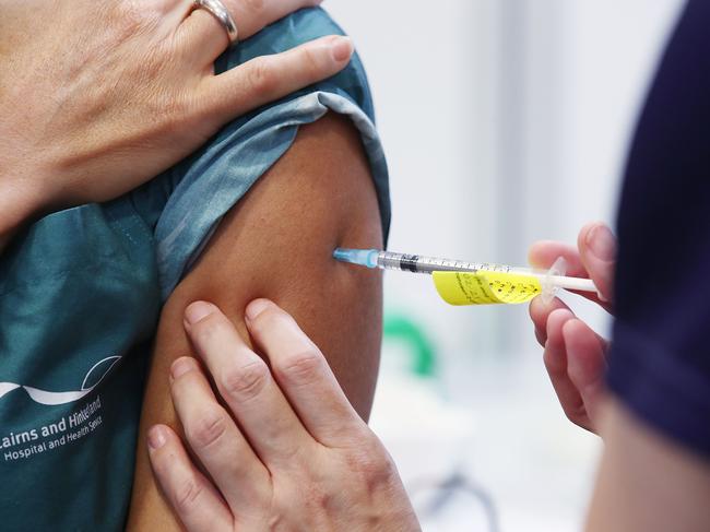 The first Pfizer COVID-19 vaccine to protect against the coronavirus has been administered for the first time in regional Queensland at the Cairns Hospital. Fever Clinic Nurse Christie King receives the vaccination from clinical nurse Camilla Clem. Picture: Brendan Radke