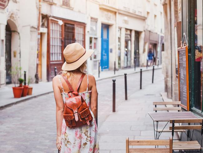 woman tourist on the street, summer fashion style, travel to Europe