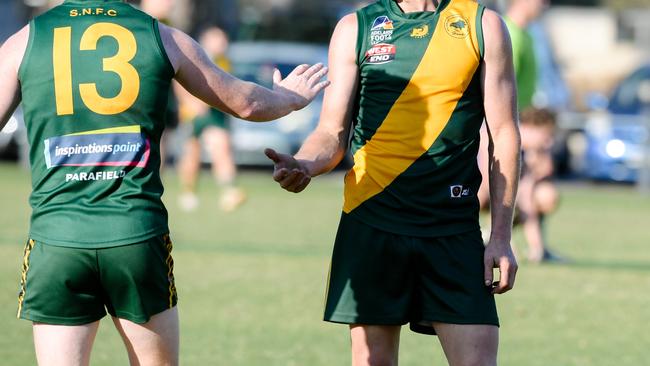 Dion Lawlor and Paul Marschall low-fiving during the Adelaide Footy League division two match between Salisbury North and Athelstone at Salisbury North Oval, Adelaide, Saturday, June 1, 2019. (AAP Image/ Morgan Sette)