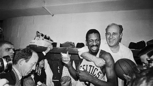 Bill Russell celebrates a championship with coach Red Auerbach.