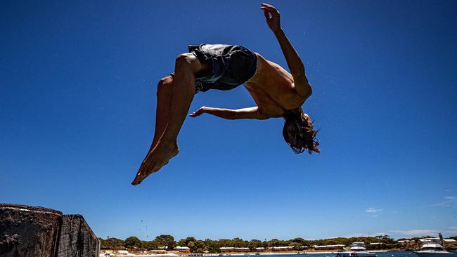 Jack Kinney-Graham does a backflip into the ocean at Rottnest Island. Picture: Colin Murty