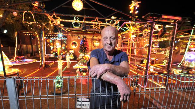 Len Doof posing with his Christmas lights display at his home in Salisbury North. Picture: File