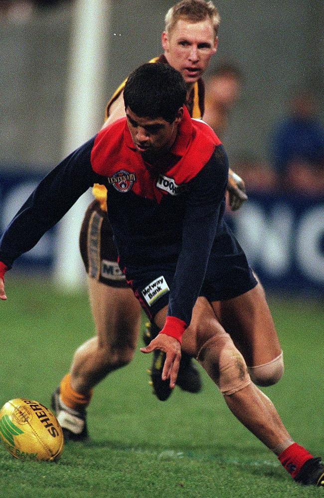 Jeff Farmer gathers the ball as Andy Collins looks on