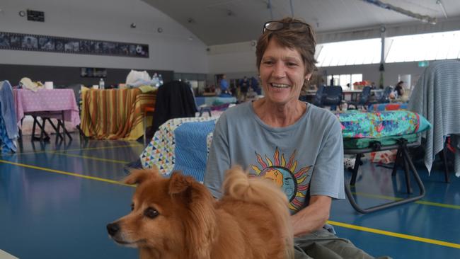 Jill Mitchell sits with a young dog in the Goonellabah Evacuation Centre after devastating floods destroyed her South Lismore home Picture: Nicholas Rupolo.