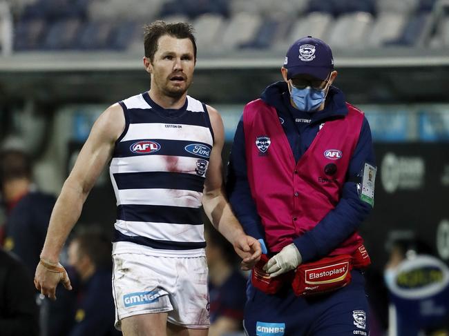 Dangerfield in the hands of a Geelong trainer in Round 23. Picture: AFL Photos/Getty Images