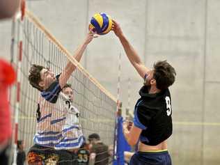 NET BATTLE: Brisbane Volleyball Club'S Connor Rudder (left) and Remember the Titans player Marco Calderini do battle at the net in the final of the Clash of the Titans volleyball tournament at Harristown State High School gym. Brisbane won the final 2-1. Picture: Kevin Farmer