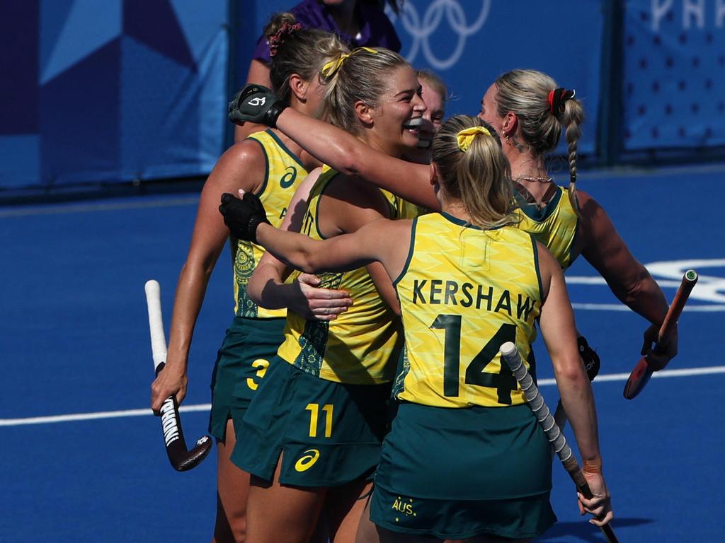 Alice Arnott celebrates with teammates after scoring their second goal in the women's pool B field hockey match between Britain and Australia. Picture: Ahmad Gharabli/AFP