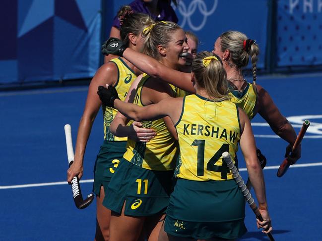 Alice Arnott celebrates with teammates after scoring their second goal in the women's pool B field hockey match between Britain and Australia. Picture: Ahmad Gharabli/AFP