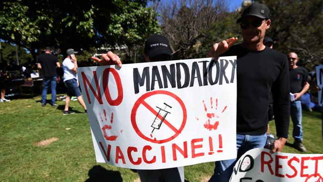 Protesters hold signs as people gather for a protest to rally for freedom of speech, movement, choice, assembly, and Health in Brisbane. Picture: NCA NewsWire / Dan Peled