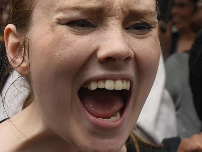 TOPSHOT - Women hold a  protest in front of Trump Tower in New York on October 4, 2018 against Supreme Court nominee Brett Kavanaugh. - Top Republicans voiced confidence Thursday that Brett Kavanaugh will be confirmed to the US Supreme Court this weekend, as they asserted that an FBI probe had found nothing to support sex assault allegations against Donald Trump's nominee."Judge Kavanaugh should be confirmed on Saturday," Senator Chuck Grassley of Iowa, the chairman of the Senate Judiciary Committee, told reporters. (Photo by TIMOTHY A. CLARY / AFP)