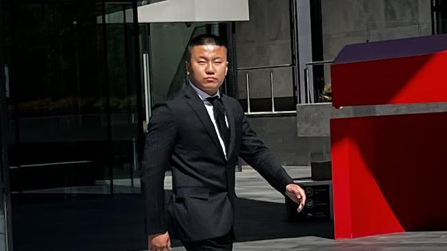 Kang Zhao (right) leaves the ACT Magistrates Court with lawyers James Maher (Middle) and Alex Cao (Left). Picture: Julia Kanapathippillai