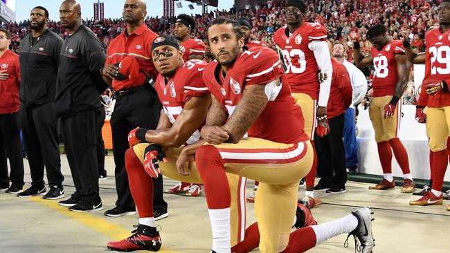 Colin Kaepernick and Eric Reid of the San Francisco 49ers kneel in protest during the national anthem prior to a game in 2016.