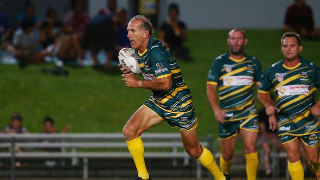 Peter Gill charges the ball up the field in the Legends of League rugby league. Photo: BRENDAN RADKE