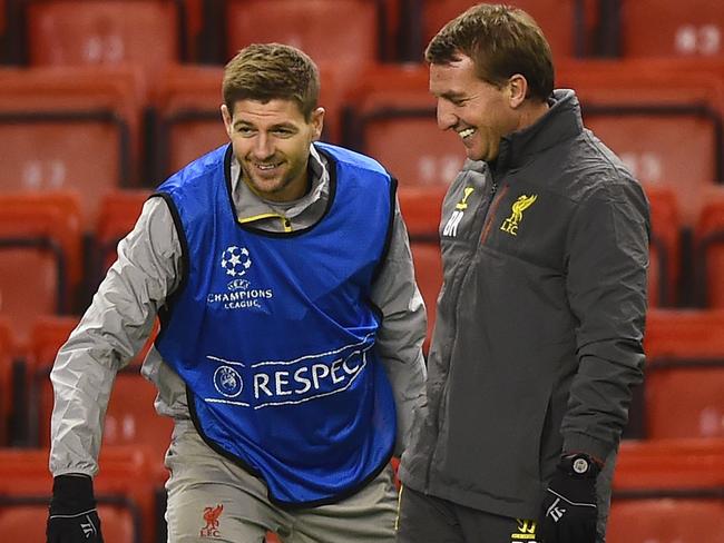 LIVERPOOL, ENGLAND - DECEMBER 08: Brendan Rodgers, manager of Liverpool smiles with Steven Gerrard during a training session ahead of the UEFA Champions League match against FC Basel 1893 at Anfield on December 8, 2014 in Liverpool, England. (Photo by Laurence Griffiths/Getty Images)