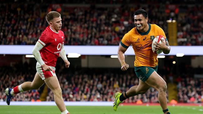 Ikitau is all smiles as he runs in to score a try against Wales. Picture: Getty