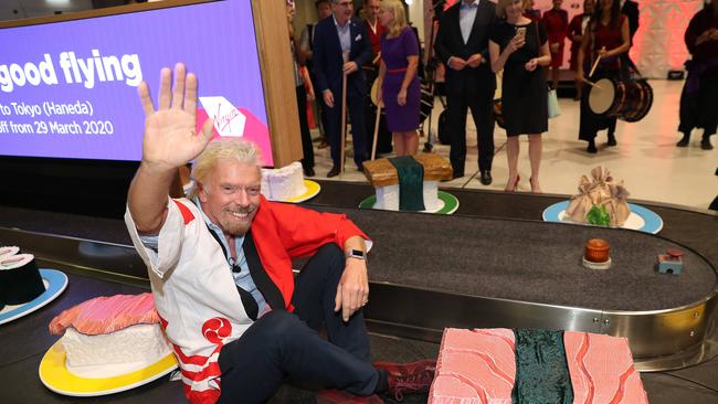 Richard Branson takes a ride on a giant sushi train, as Virgin Australia promoted their new Brisbane-Tokyo route, at Brisbane Airport. Photographer: Liam Kidston.