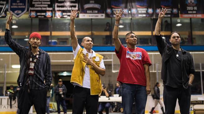 Freedom: The Fairbanks Four, from left, George Frese, Marvin Roberts, Eugene Vent, and Kevin Pease, raise four fingers, displaying the symbol of their struggle, during an event in the honour. Picture: Loren Holmes/Alaska Dispatch News