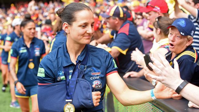 Pleasure and pain ... Heather Anderson nurses her damaged shoulder as she greets Crows fans at Adelaide Oval. Picture: Tom Huntley