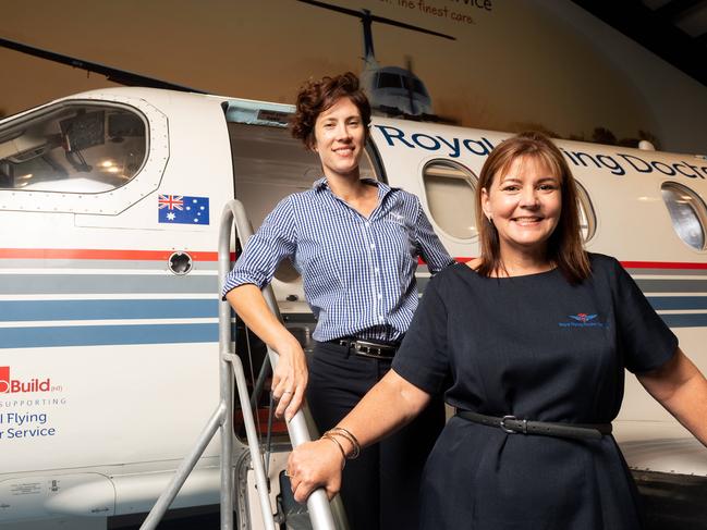 RFDS is reopening Friday June 5 and said it is important for operators and locals alike to support one another. Noni Romano and Sam Bennett are pictured with a decommissioned RFDS plane inside the facility. Picture: Che Chorley