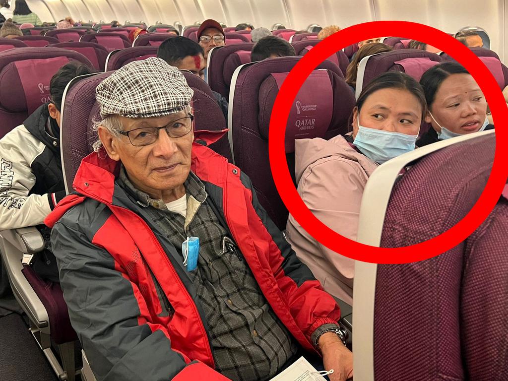 A woman reacts as French serial killer Charles Sobhraj sits in a domestic aircraft. Picture: AFP