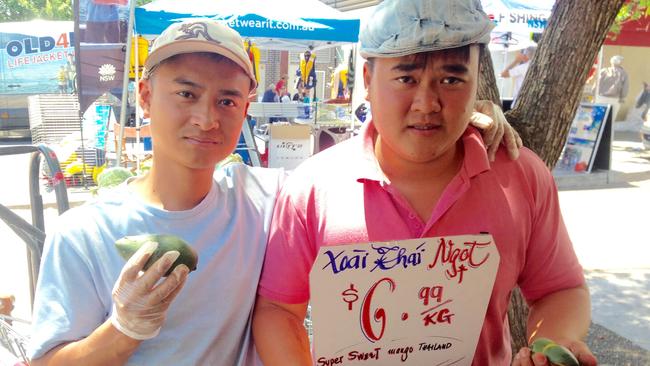 Vietnamese grocers Tuan Pham and Bao Pham with sweet Thai mango at Viet Phat greengrocers in Bankstown. Picture: Antony Field