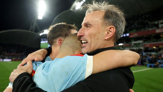 MELBOURNE, AUSTRALIA - MAY 31: City Head Coach Aurelio Vidmar, Kai Trewin and Aziz Behich embrace after winning the A-League Men Grand Final match between Melbourne City and Melbourne Victory at AAMI Park on May 31, 2025, in Melbourne, Australia. (Photo by Robert Cianflone/Getty Images)