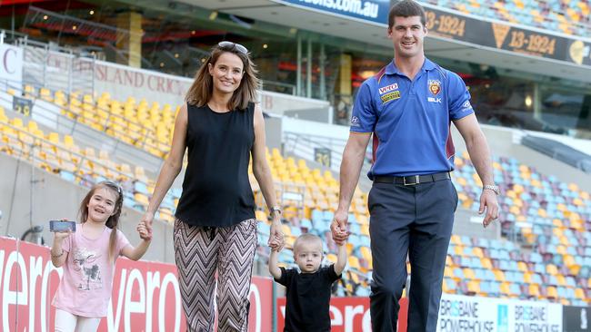 Brisbane Lions player Jonathan Brown with daughter Olivia, wife Kylie and son Jack as he announces his retirement from AFL in 2014. Picture: Jono Searle