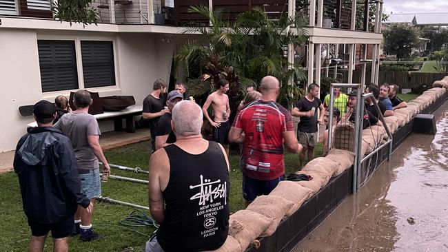 Grafton residents were quick to think on their feet, catching the flood before it could engulf the street. Picture: Lexi Lamberth