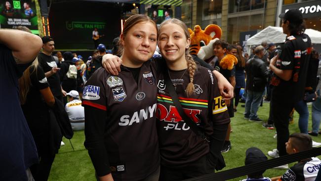 Panthers fan Hannah Maher convinced Eels supporter Brooke Challenor to don a Penrith jersey. Picture: Richard Dobson