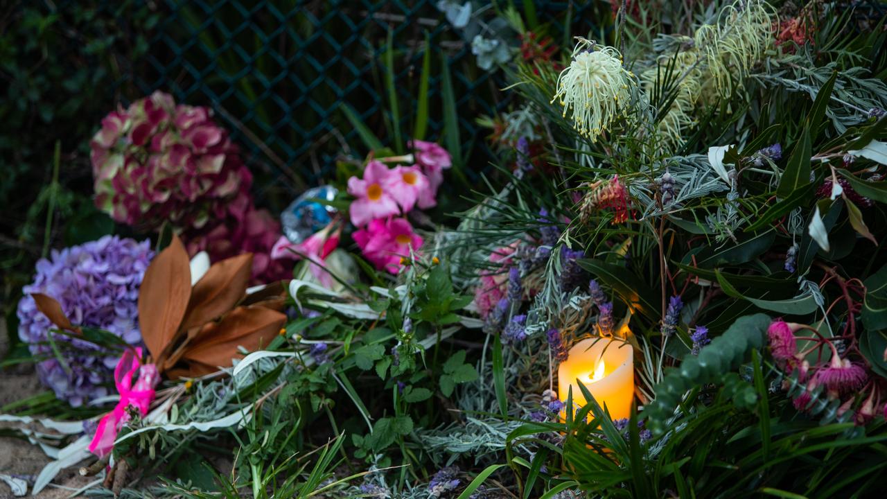 The tributes included sorrowful messages and flickering candles. Picture: Julian Andrews