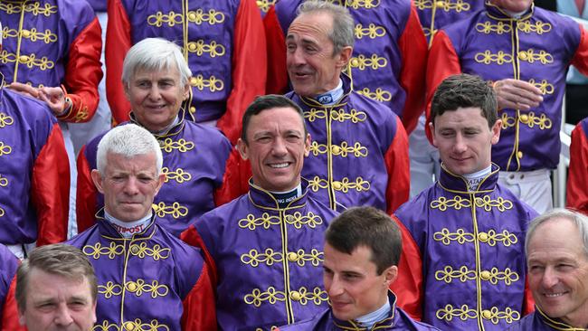 Jockeys, past and present, who have ridden for Britain's Queen Elizabeth II. Form a guard of honour. Picture: AFP.