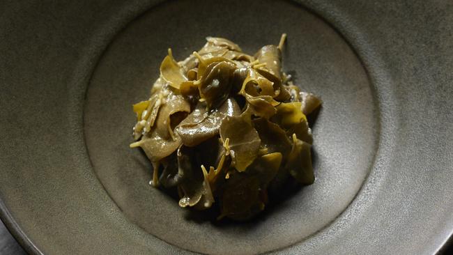 Veal tartare hidden under braised saltbush is more traditional than other dishes on the menu.