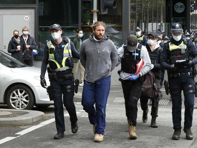 Members of Victorian Police arrest a man on Elizabeth St during an anti-COVID lockdown protest in 2021. Picture: Darrian Traynor/Getty Images