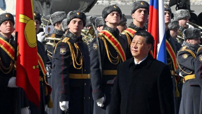 Chinese President Xi Jinping walks past honour guards during a welcoming ceremony at Moscow’s Vnukovo airport on Monday. Picture: AFP