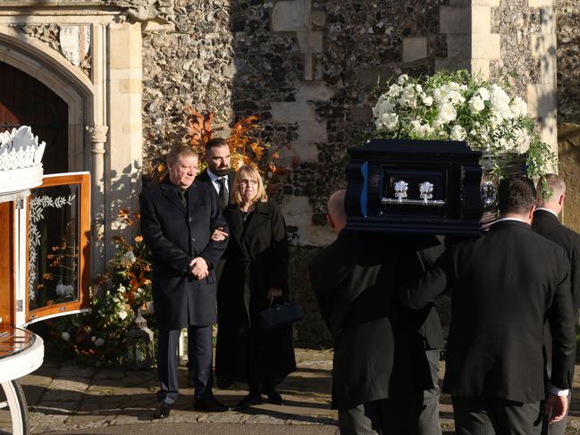 The parents of Liam Payne, Karen and Geoff Payne, watch as his coffin is carried into the funeral. Picture: Getty Images.