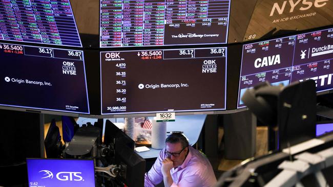 A trader on the floor of the New York Stock Exchange (NYSE) monitors stocks on Monday. Picture: AFP
