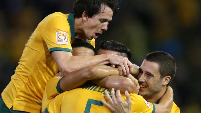 Australia's Jason Davidson celebrates with team mates after scoring a goal during the Asian Cup Semi Final between Australia and UAE at Hunter Stadium , Newcastle .Picture Gregg Porteous