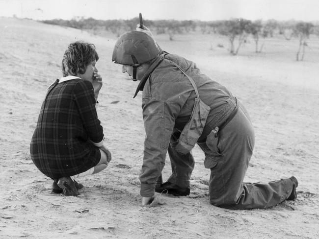 1970: Detective Sergeant R.P. Giles talks to a shaken Monica Schiller shortly after she had been freed from prison escapees who had taken her hostage. The three men were recaptured in a dramatic confrontation with police on the Birdsville Track. Picture: Ray Titus/File