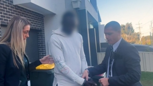 Detectives charged Daniel Santino (centre) at Guildford. Picture: NSW Police