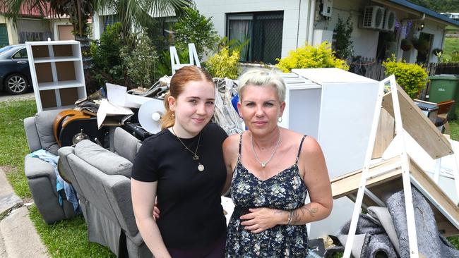 Hailey Heusdens with her mum Kerri Dowd outside their Kamerunga Villas home two weeks after flooding of the Barron River cut power to 131 properties. Picture: Peter Carruthers