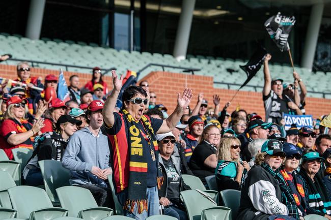 Crows and Port Adelaide fans cheering and sitting together on the southern side of Adelaide Oval as extras in the film 