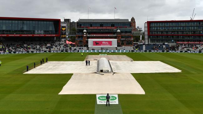 Covers on the wicket as rain disrupts play on day one. Picture: AFP